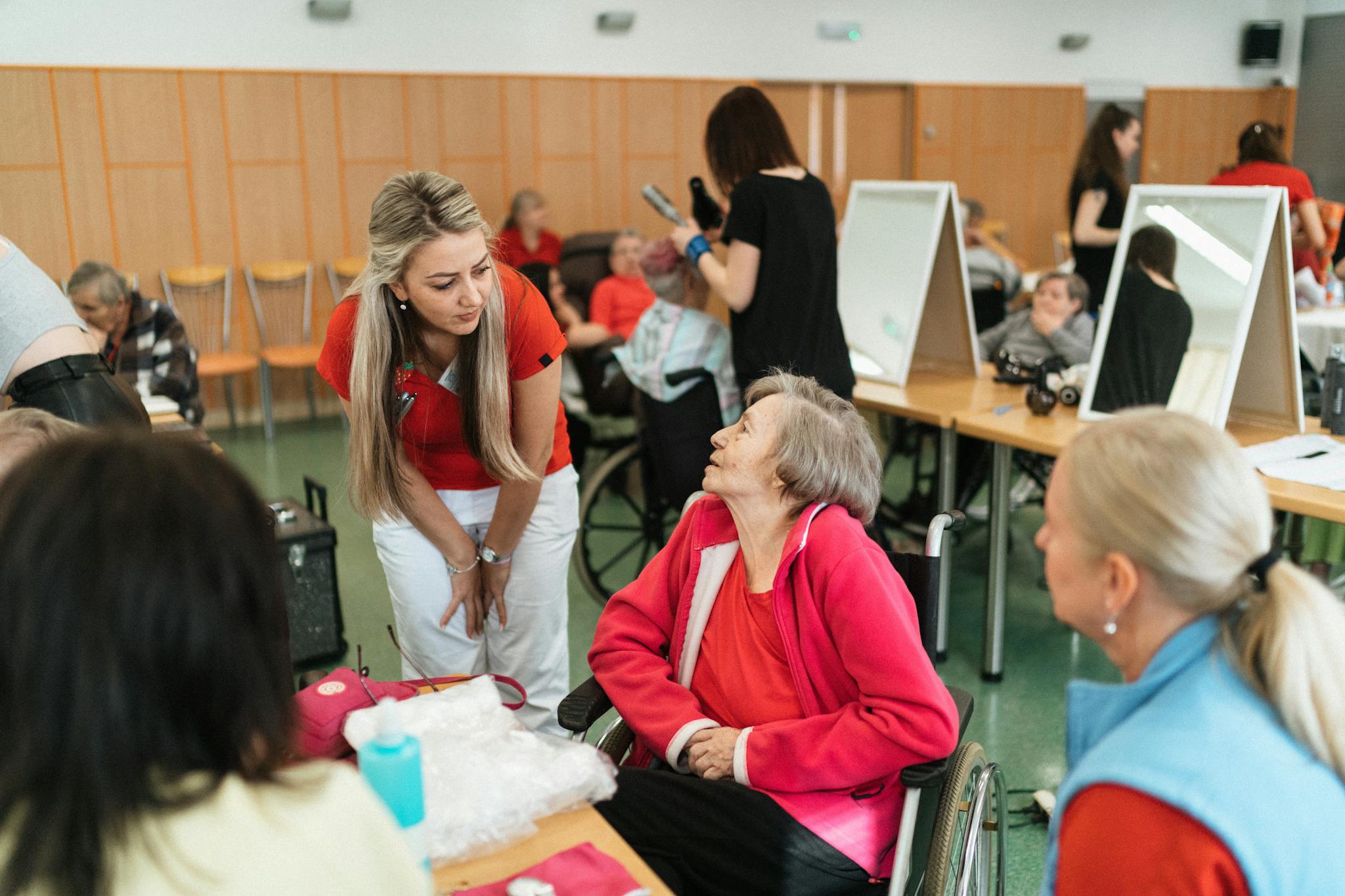 Friendly interaction between caregivers and seniors in a care facility.